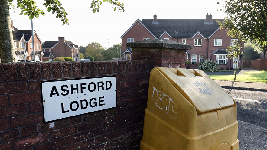 Ashford Lodge sign beside the entrance to a residential area with large semi-detached houses