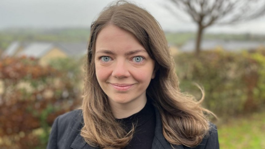 Rebecca Montacute smiling in front of countryside