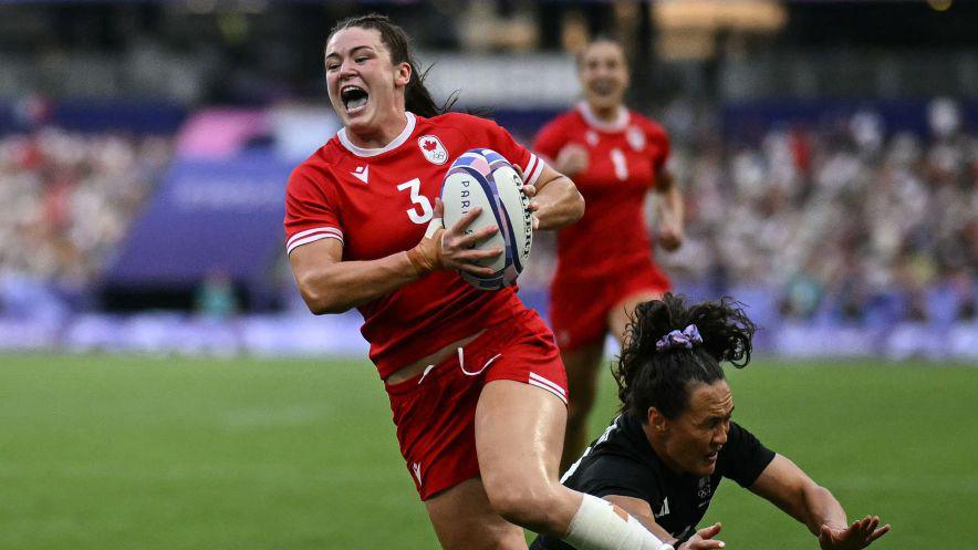 Alysha Corrign breaks through a tackle during the rugby sevens gold medal match with New Zealand