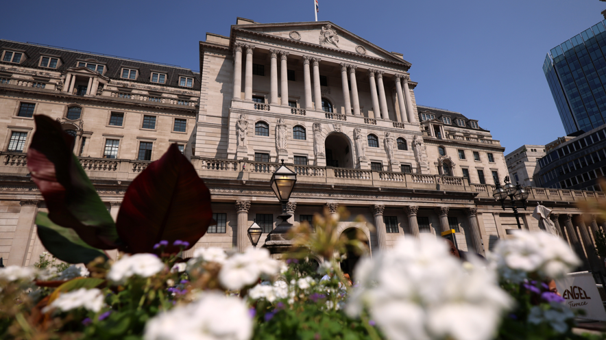 Bank of England building with white and purple flowers in the foreground