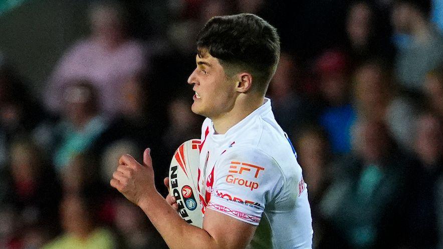Jon Bennison carrying the ball under his right arm for St Helens