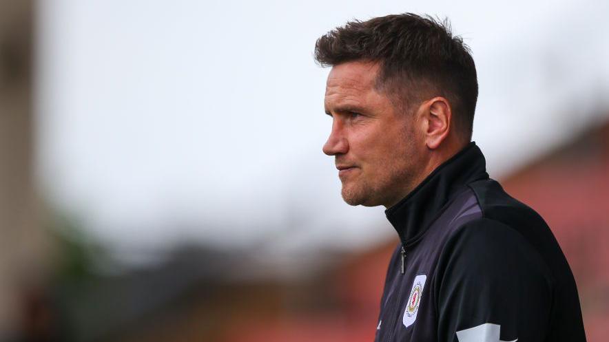 Crewe Alexandra boss Lee Bell looks on from the touchline 