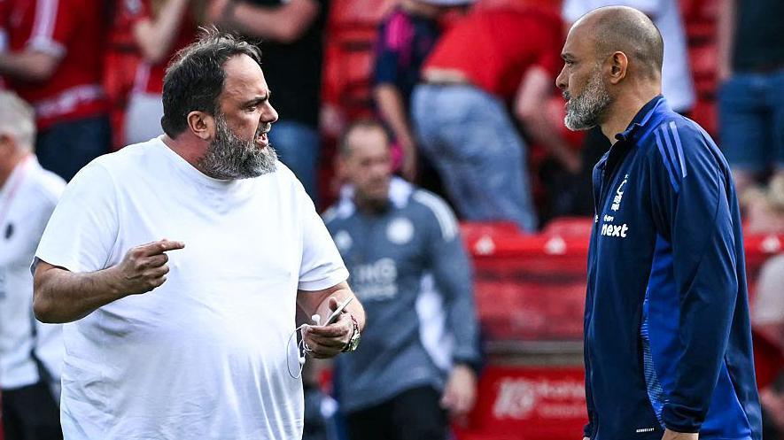 Evangelos Marinakis speaking to Nuno Espirito Santo on the pitch after a game against Leicester last season.