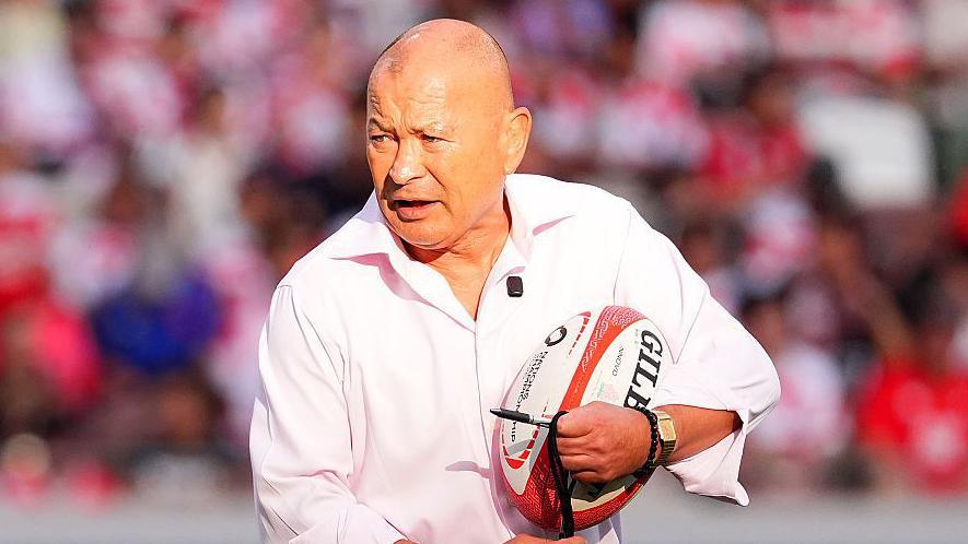 Japan coach Eddie Jones holding a rugby ball