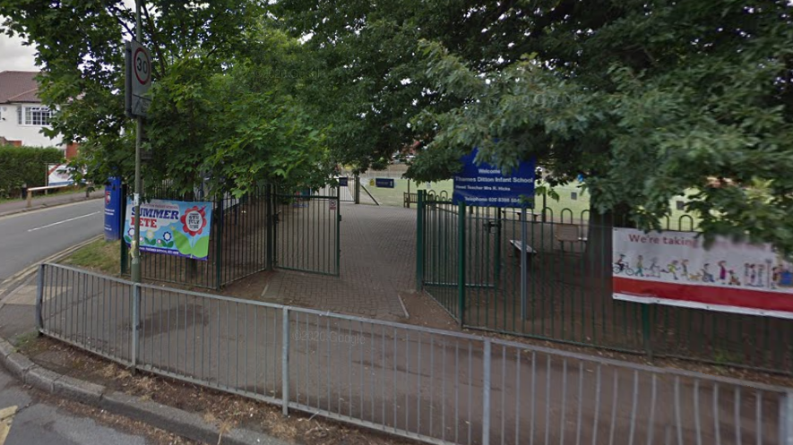 A Google Street image of the front gates of the school. There is a blue sign which says "Thames Ditton Infant School".