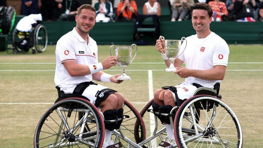Alfie Hewett and Gordon Reid pose with their winners' trophies at Wimbledon in 2024
