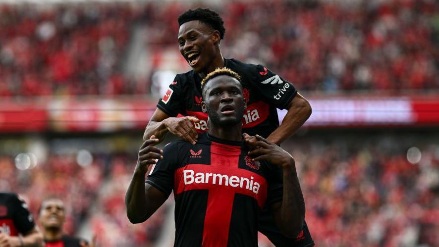 Victor Boniface is mobbed by a team-mate after scoring