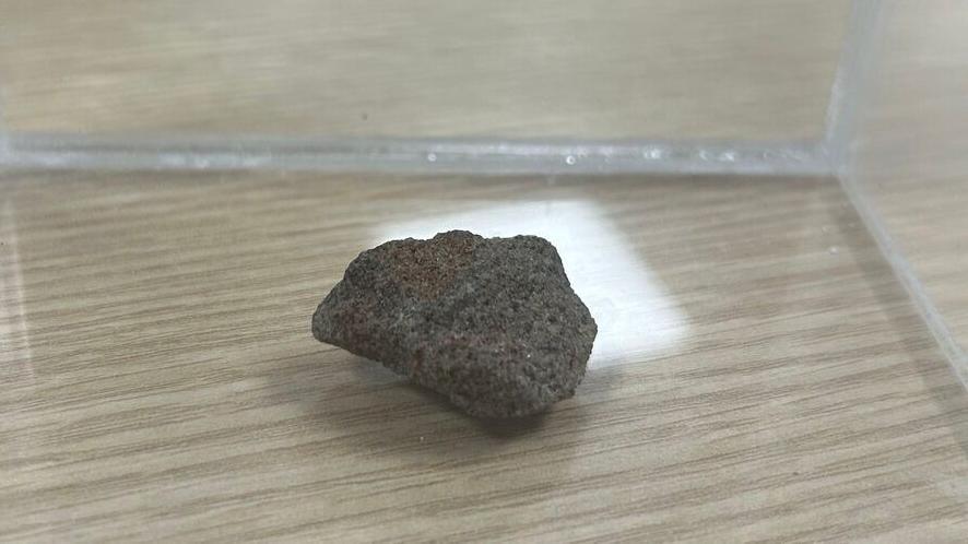 A fragment of the Stone of Destiny that was gifted to Alex Salmond and was kept at the SNP's headquarters. It is a grey stone and sits inside a clear case.