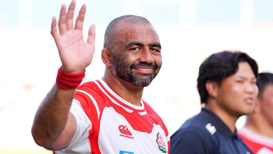 Japan captain Michael Leitch waves towards the camera