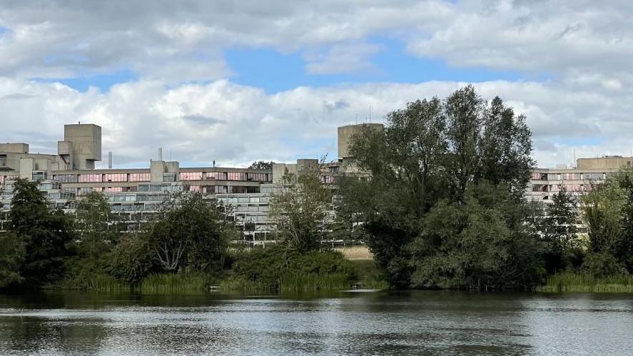 University of East Anglia, a brutalist building with a large lake to its front. 