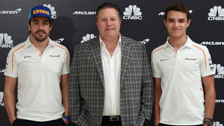 Fernando Alonso, Zak Brown and Lando Norris stood adjacent  to each   different   astatine  Abu Dhabi successful  2018. Alonso and Norris are some  wearing McLaren polo shirts