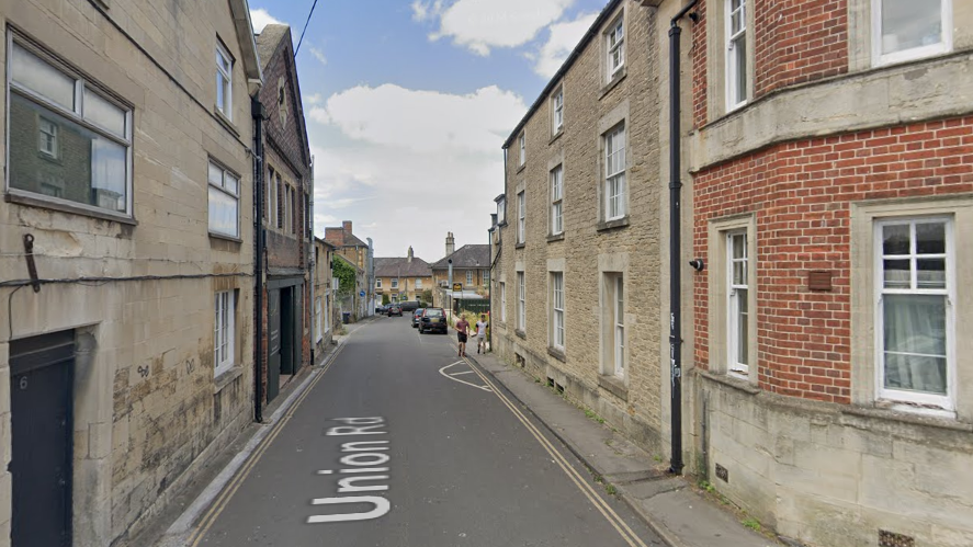 Union Road in Chippenham. It is a small, lane-like road with business premises either side. There is a small pavement on the right hand side.