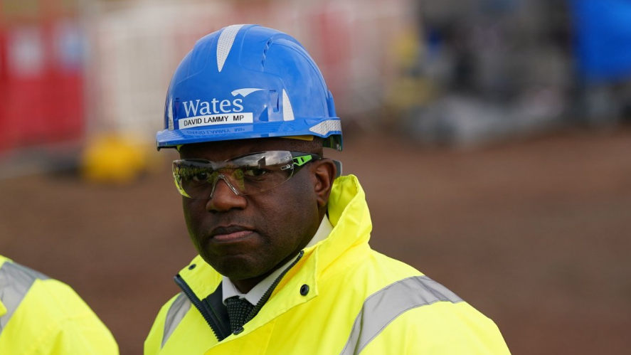 A man in a blue hard-had and high visibility clothing