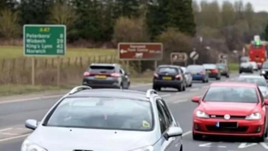 Cars driving on a road in both directions