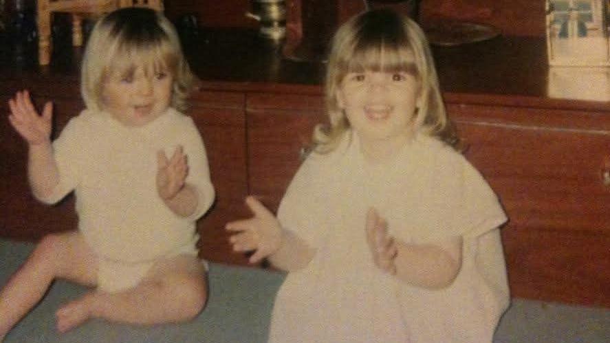 A picture of Nikita Dallison and Mellissa Arkwright in 1994. Both girls are smiling and clapping in the image.