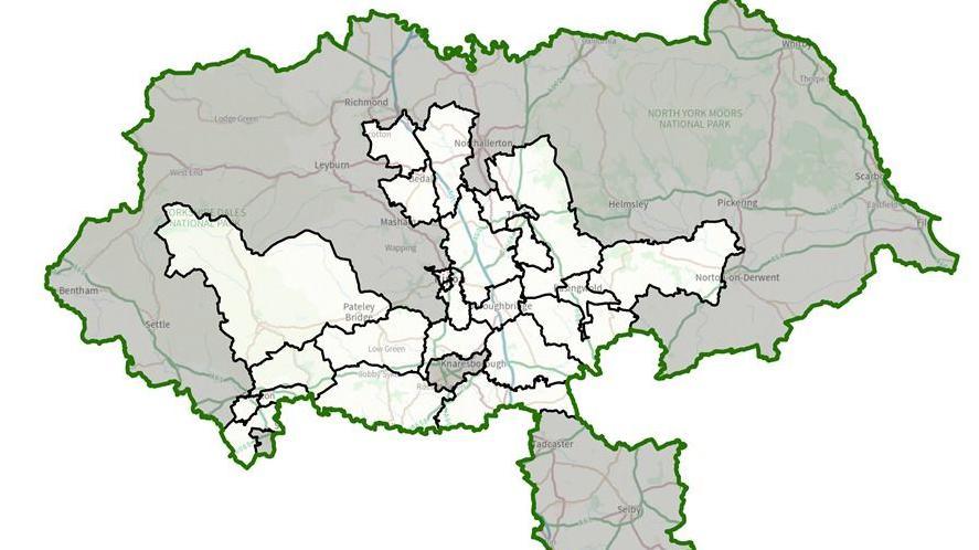 A white map showing the North Yorkshire Council area with some areas highlighted in grey and the whole map outlined in green