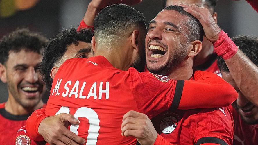 Ramy Rabia of Egypt celebrates with Mohamed Salah