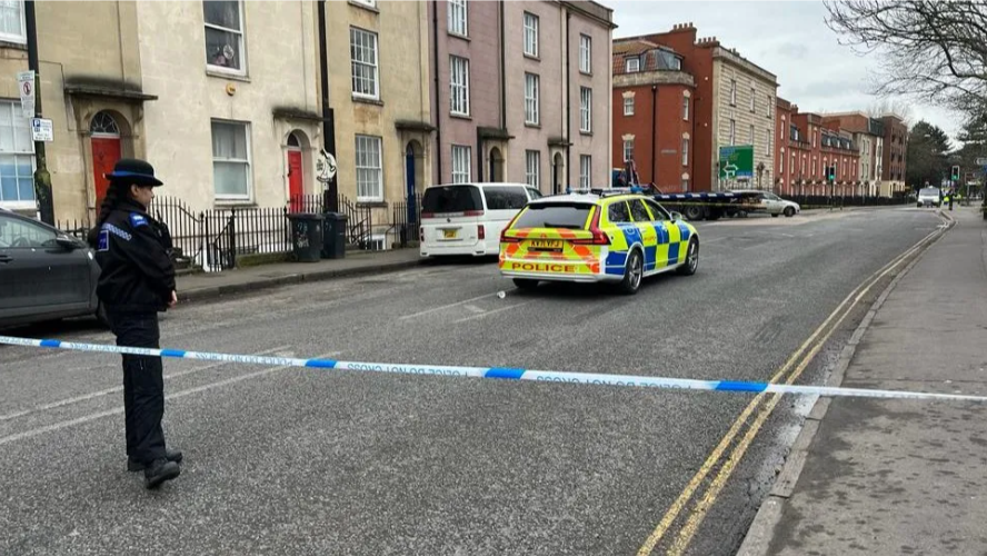 A police officer stands by police tape on York Road in Bedminster, Bristol