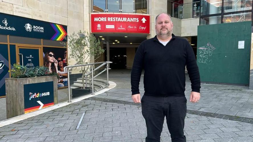 Swindon Borough Council leader Jim Robbins standing in front of empty units at Regent Circus in the town centre.