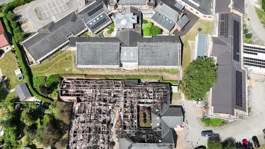 An aerial shot of the Malton hospital site showing the burnt remains of one building and other buildings with solar panels on the roof.