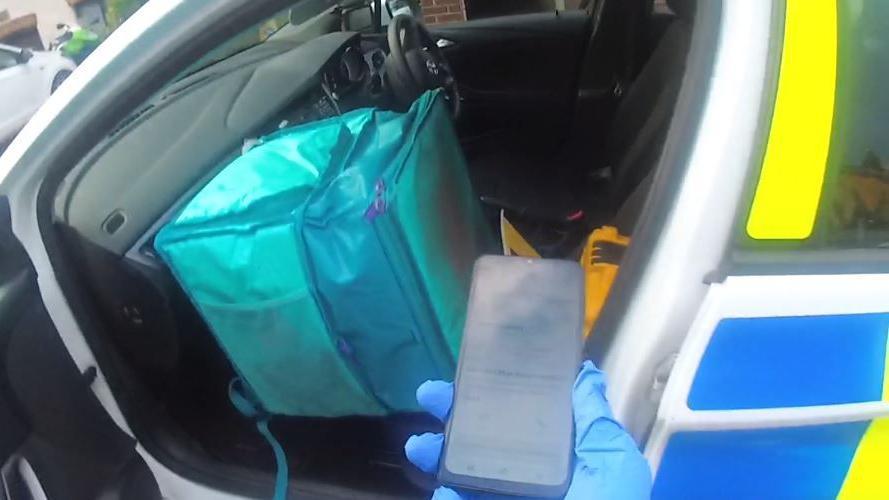 Officers with the food delivery in their police car