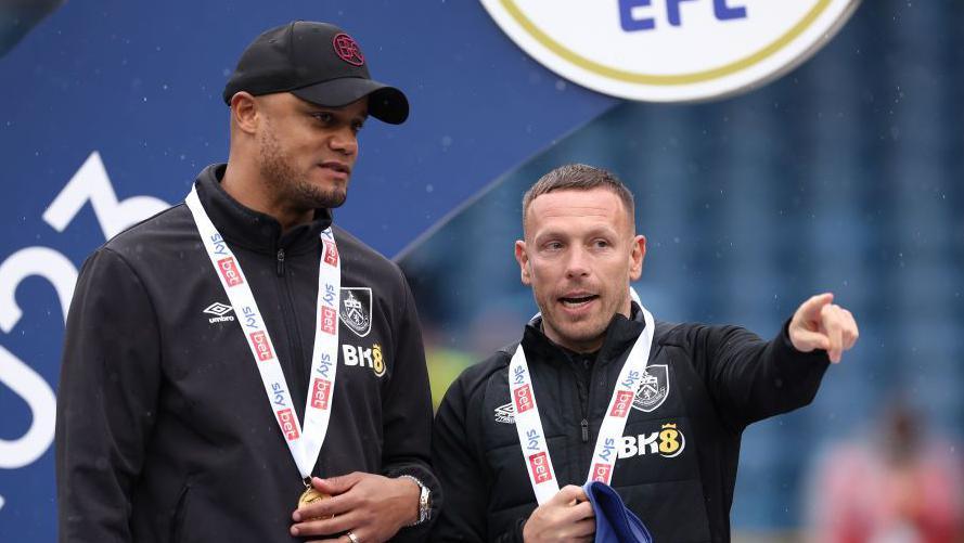 Vincent Kompany and Craig Bellamy with Championship medals at Burnley in 2023