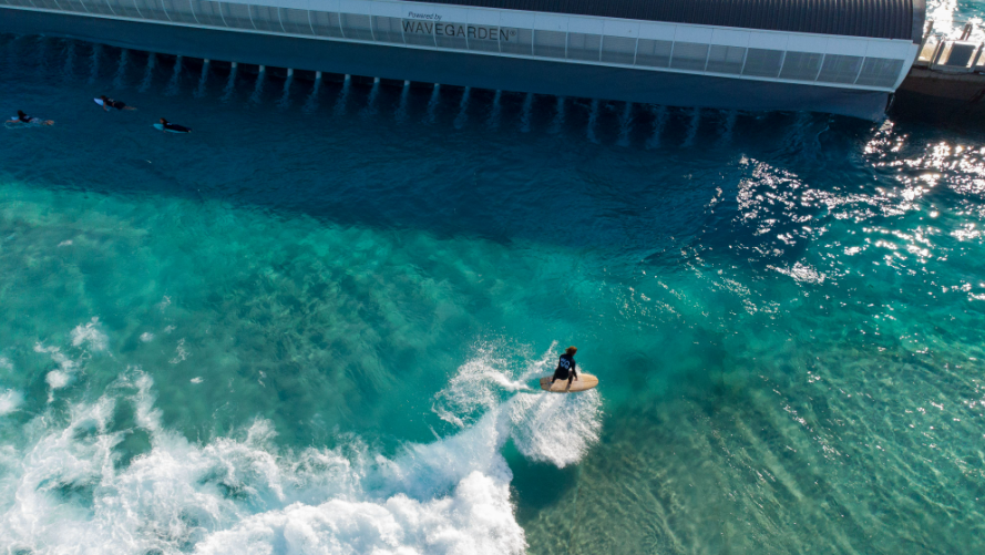 Taken from a drone, a person can be seen surfing on The Wave complex water