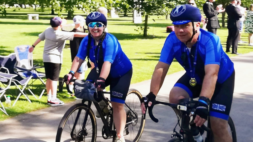 Mr Wiltshire and his daughter cycling in a park