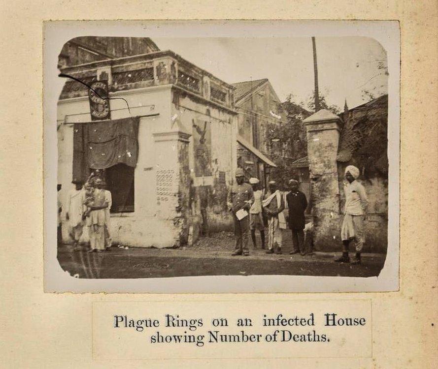 Rings chalked on a Bombay home showing the number of plague cases within