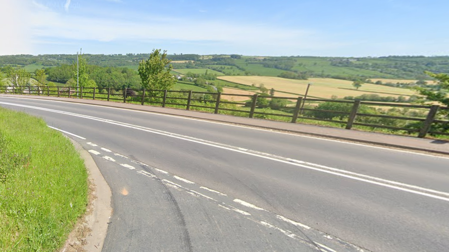 A google maps image of the A30, with fields either side of the road and woodland in the distance