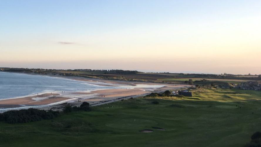 A panoramic view of Alnmouth golf club with the beach behind