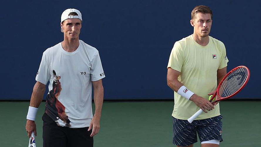 Joe Salisbury and Neal Skupski are holding tennis racquets