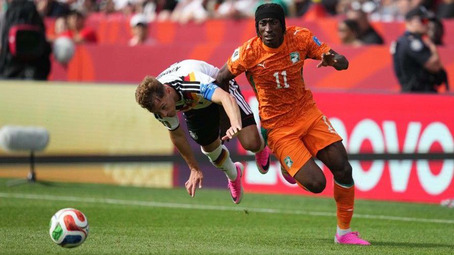 Ivory Coast defender Yan Diomande and Germany's Joshua Kimmich battle for the ball at the 2026 World Cup 