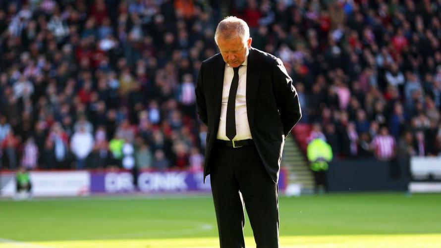 Sheffield United head coach Chris Wilder with his head bowed in memory of his former player George Baldock