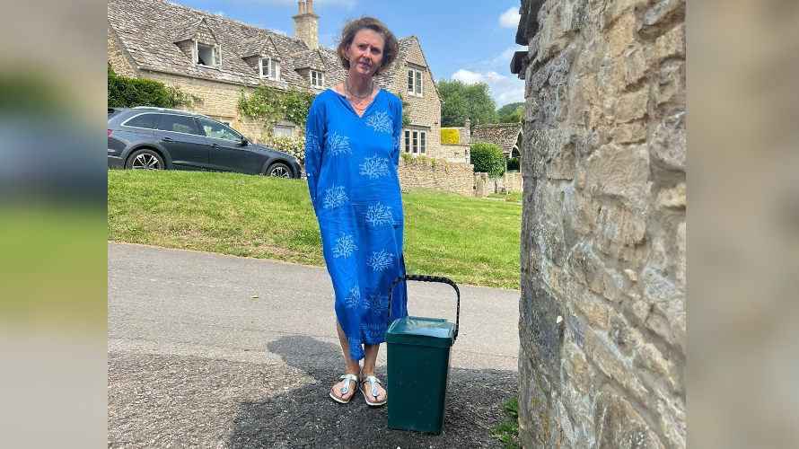 Julia Judd stood next to a food bin in a Cotswolds village