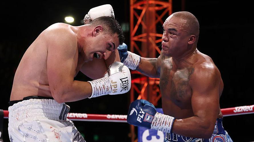 Justis Huni covers up from a punch from Fabio Wardley