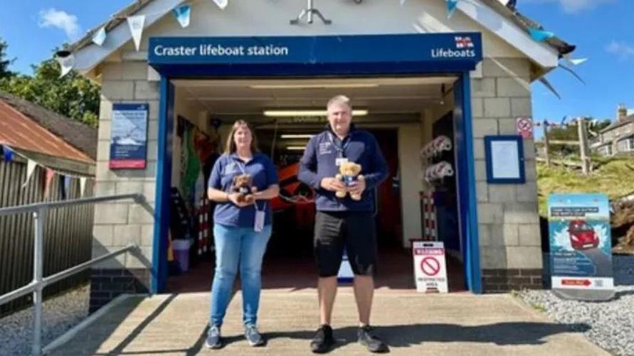 Allan and Helen Thornhill standing outside a lifeboat station