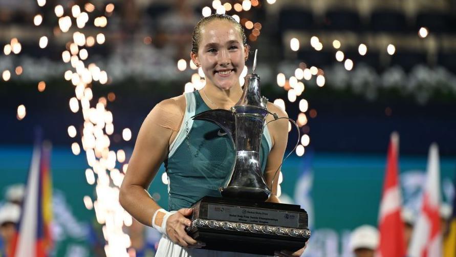 Mirra Andreeva celebrates with the Dubai Tennis Championships trophy