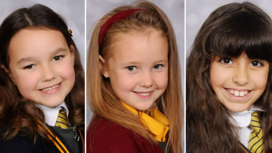Image shows Bebe King, Elsie Dot Stancombe and Alice Aguiar, posing for school photographs in their uniforms