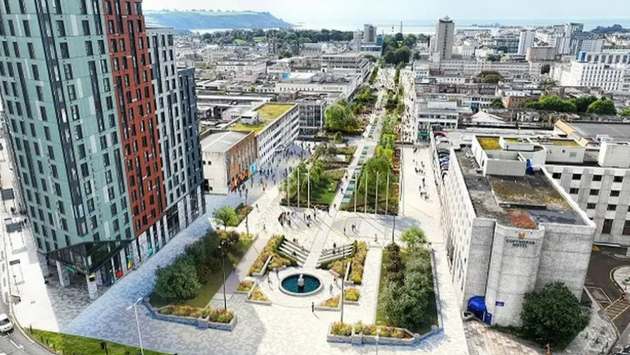 An aerial view of the regeneration project at Armada Way. Trees line the granite paving. Buildings surround the area.