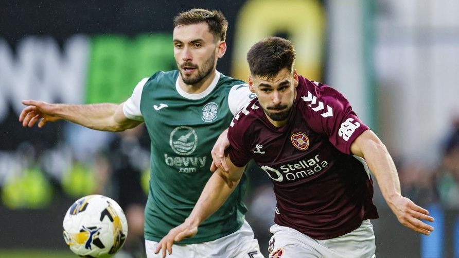 Hearts' Claudio Braga (right) and Hibernian's Warren O'Hora