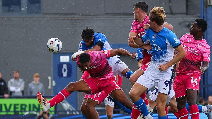 Kyle Wootton heads Stockport's second goal