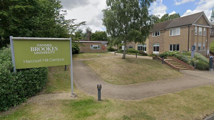 Oxford Brookes' Harcourt Hill campus. There is a green sign in front of two buildings.