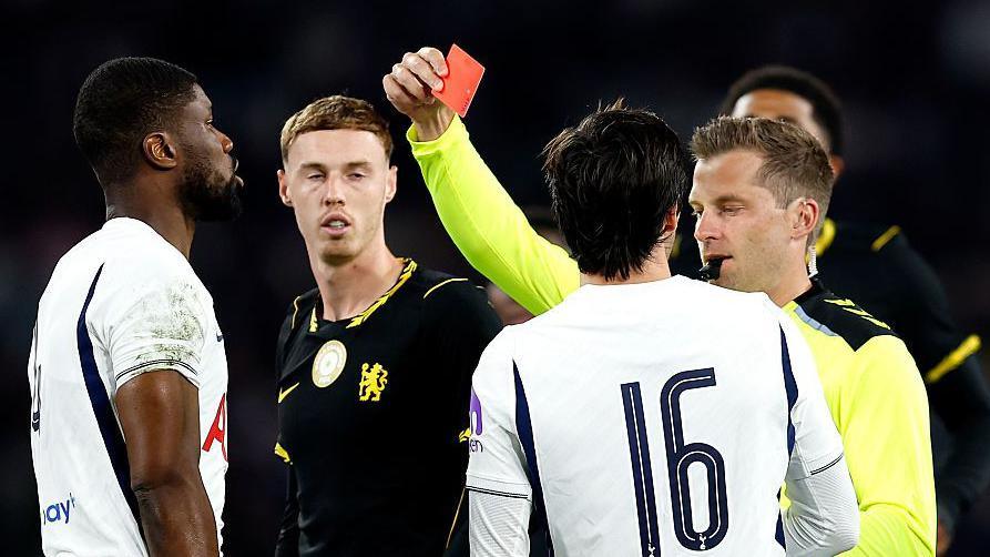 Kevin Danso is shown a red card in Sydney