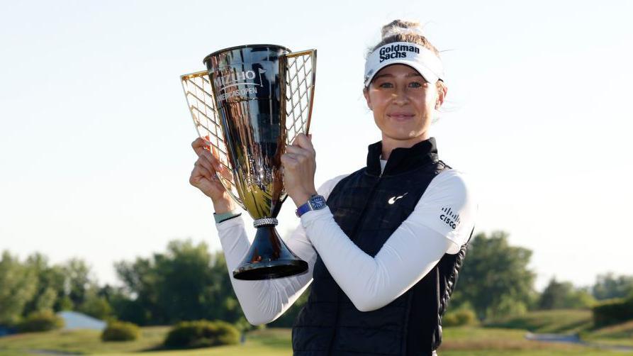 Nelly Korda holds trophy