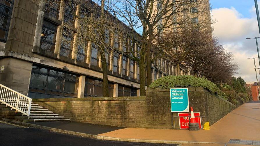 A street view of Oldham Council buildings, including a street sign