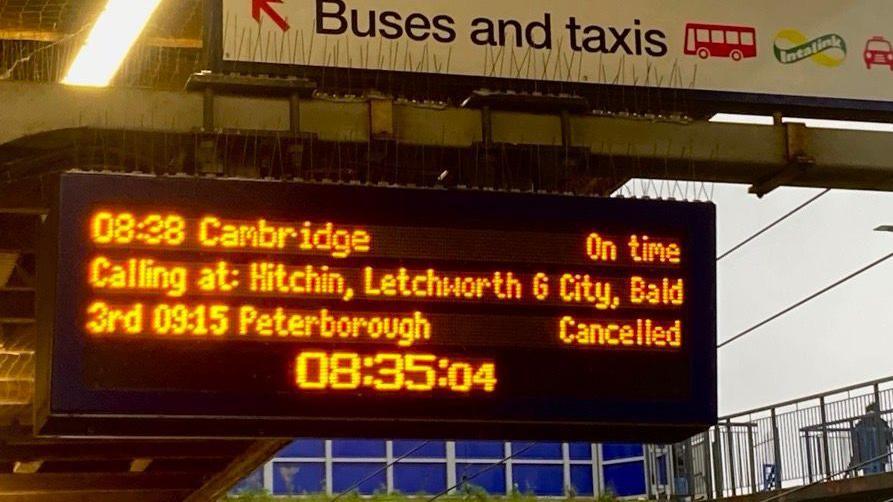 An electronic board displaying the cancelled services at Stevenage station