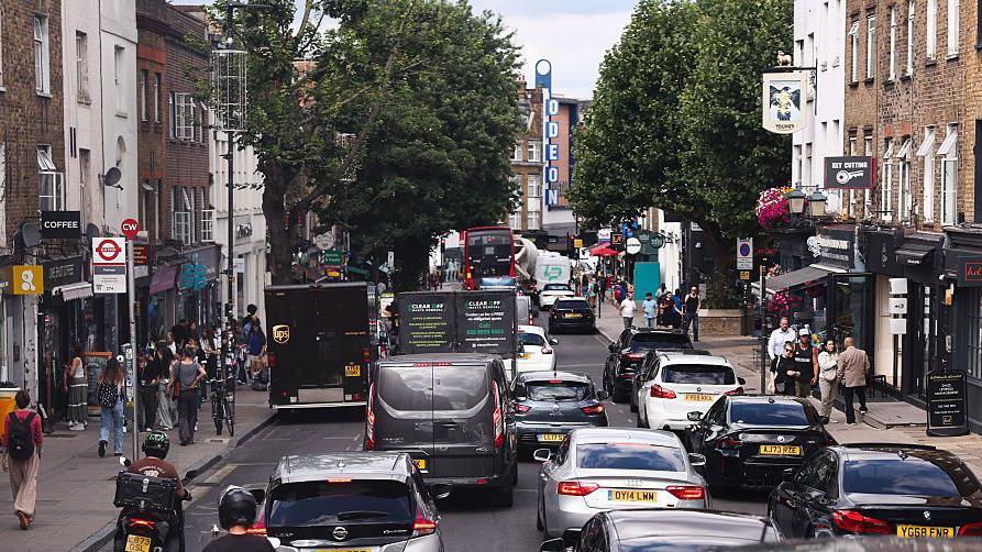 A long line of cars on a busy London street