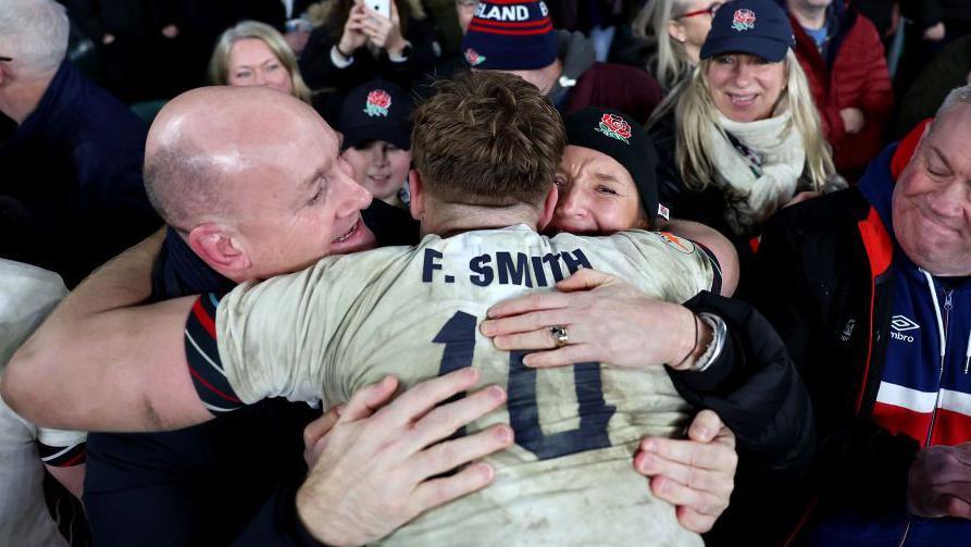  Fin Smith of England embraces with his parent