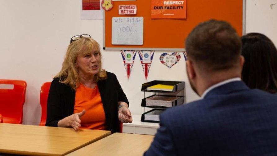 Christine Seddon in a tangerine top speaks at the launch of the Football Governance Bill